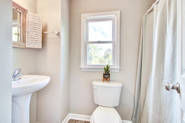 1834 Cornish Ave, Charleston, SC 29412 - bathroom with toilet, baseboards, a sink, and a shower with curtain
