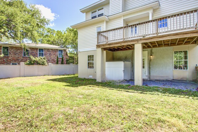 1834 Cornish Ave, Charleston, SC 29412 - rear view of property featuring a lawn, fence, stucco siding, and a deck