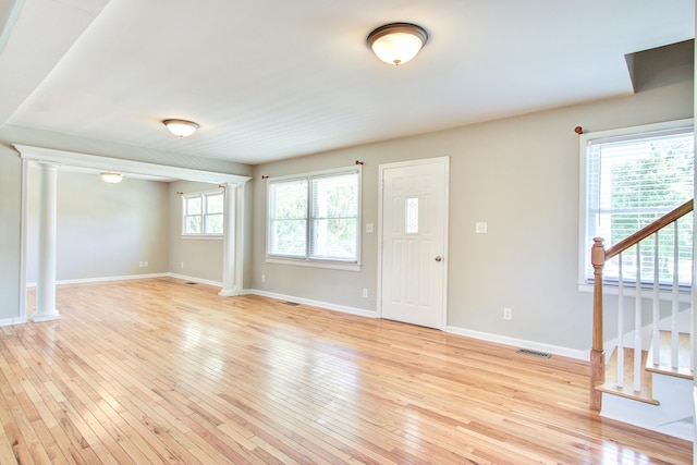 1834 Cornish Ave, Charleston, SC 29412 - entryway featuring light wood-style floors, baseboards, stairway, and decorative columns