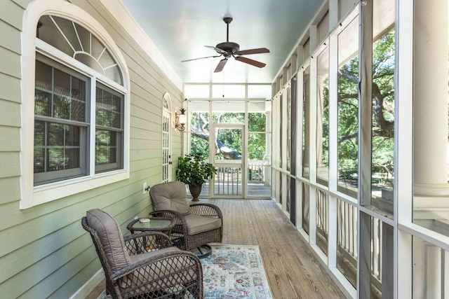 sunroom featuring a ceiling fan