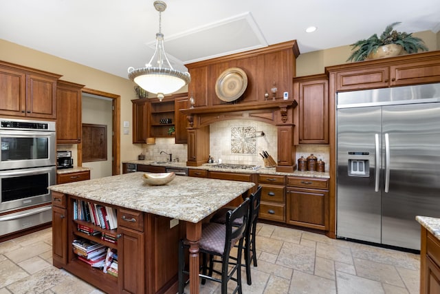 kitchen featuring stone tile floors, a kitchen island, appliances with stainless steel finishes, a warming drawer, and open shelves