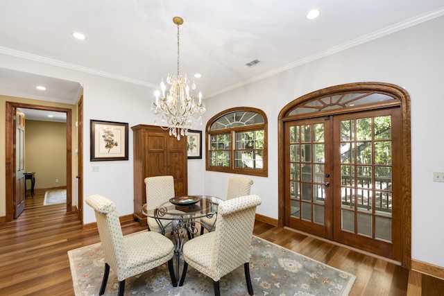 dining space with dark wood-style floors, a wealth of natural light, and french doors