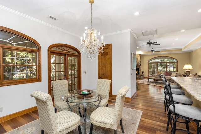 dining space with french doors, recessed lighting, dark wood-type flooring, ornamental molding, and baseboards