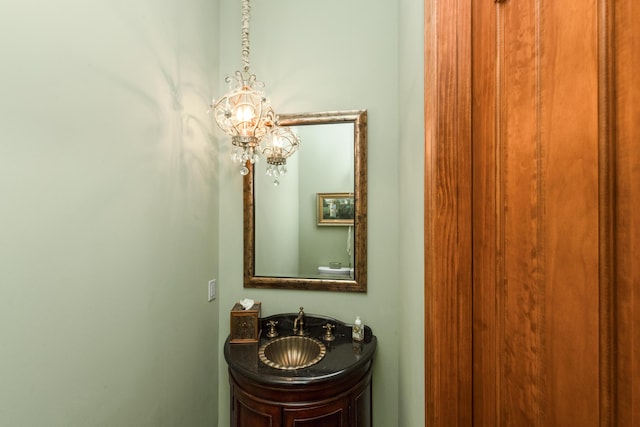 bathroom featuring a notable chandelier and vanity