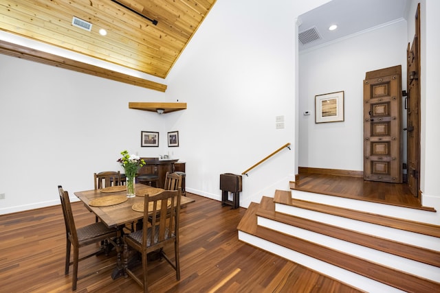 dining space featuring dark wood-type flooring, visible vents, baseboards, stairs, and crown molding