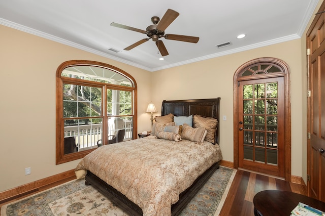 bedroom featuring multiple windows, visible vents, and dark wood-style flooring