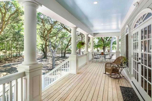 wooden terrace featuring a porch and french doors