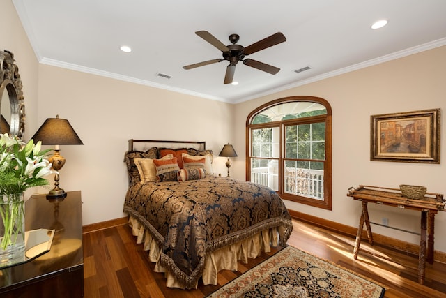 bedroom with ornamental molding, dark wood-type flooring, visible vents, and baseboards