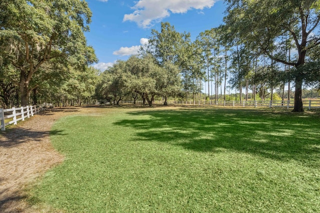 view of yard featuring a rural view and fence