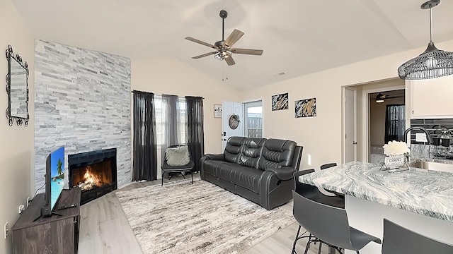 2172 Palermo Pl, North Charleston, SC 29406 - living area with ceiling fan, a tiled fireplace, lofted ceiling, and light wood-style flooring