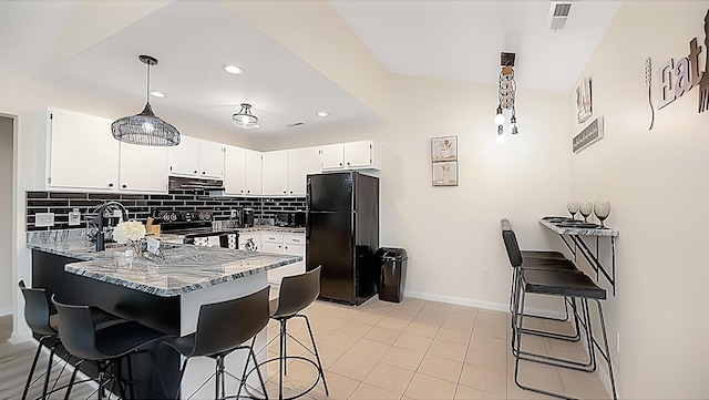 2172 Palermo Pl, North Charleston, SC 29406 - kitchen featuring black appliances, extractor fan, a peninsula, light stone countertops, and tasteful backsplash