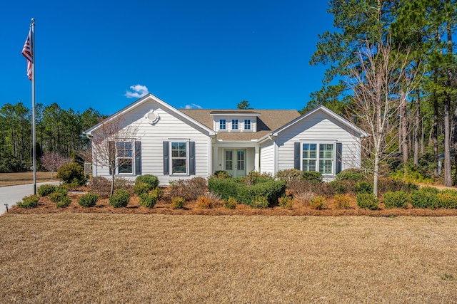 view of front of property featuring a front lawn and french doors