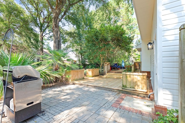 view of patio / terrace featuring a grill and a deck