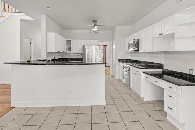 kitchen featuring backsplash, light tile patterned floors, appliances with stainless steel finishes, a ceiling fan, and open shelves