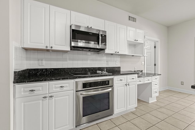 kitchen featuring visible vents, appliances with stainless steel finishes, and white cabinetry