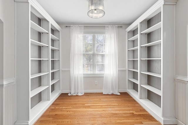 walk in closet with wood finished floors