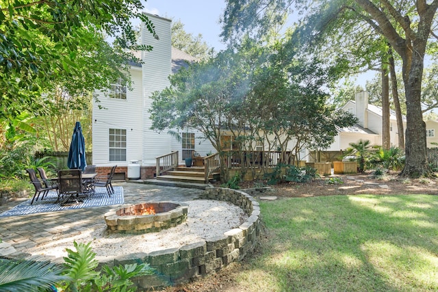 view of yard with a patio, a fire pit, and a deck