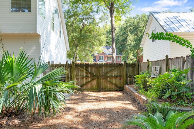 view of yard featuring fence and a gate