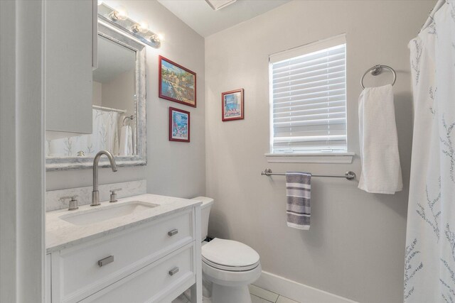 bathroom featuring tile patterned flooring, vanity, and toilet