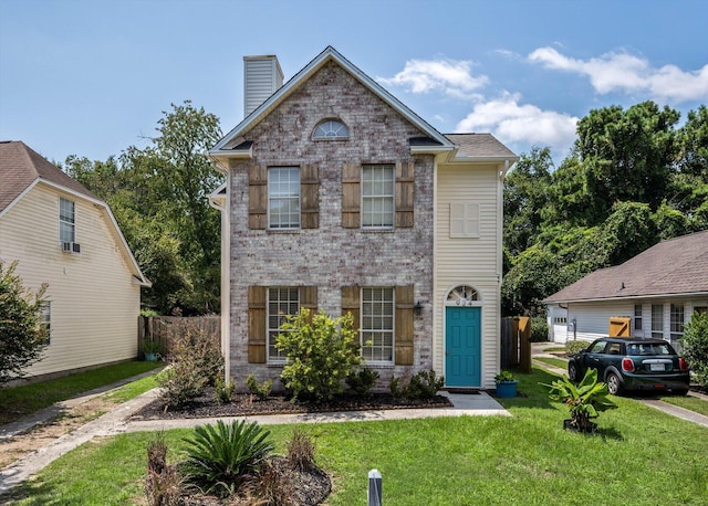 traditional home with brick siding, fence, a chimney, and a front lawn