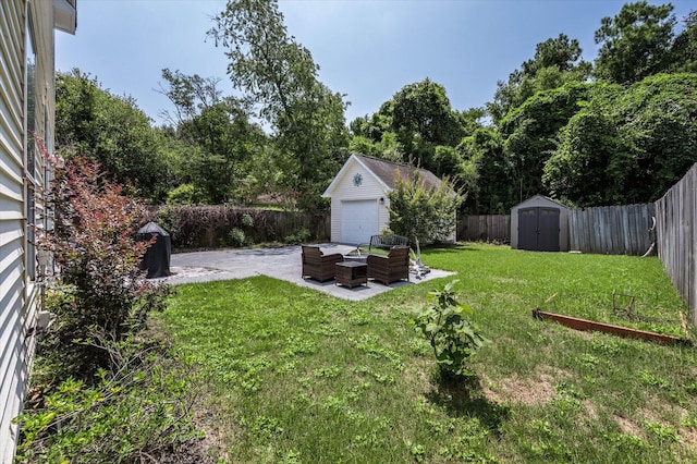 view of yard featuring an outbuilding, a shed, a patio area, and a fenced backyard