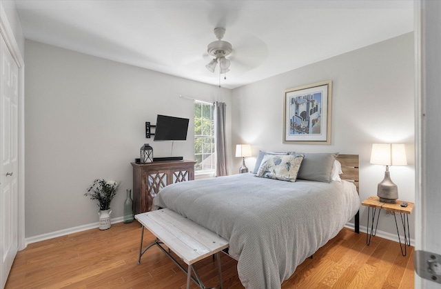 bedroom featuring a ceiling fan, light wood-type flooring, and baseboards