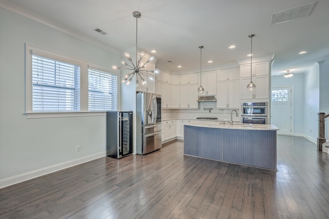 kitchen featuring appliances with stainless steel finishes, dark hardwood / wood-style floors, white cabinetry, and plenty of natural light