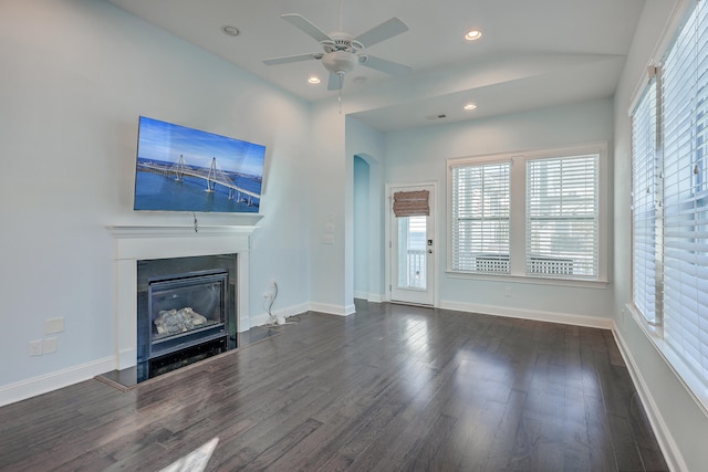 unfurnished living room with dark wood-type flooring and ceiling fan