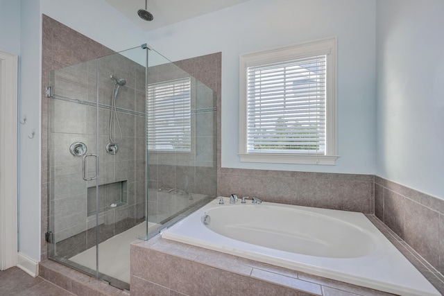 bathroom featuring separate shower and tub