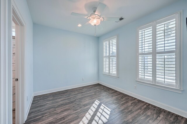 spare room with ceiling fan and dark hardwood / wood-style flooring