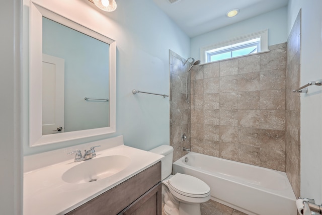 full bathroom featuring toilet, tiled shower / bath combo, and vanity