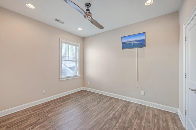 spare room with wood-type flooring and ceiling fan