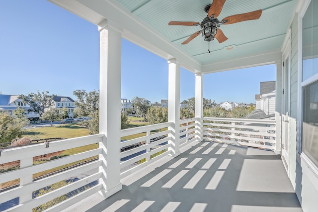 view of patio with ceiling fan and a balcony