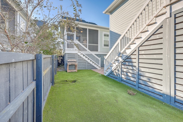 view of yard featuring a sunroom