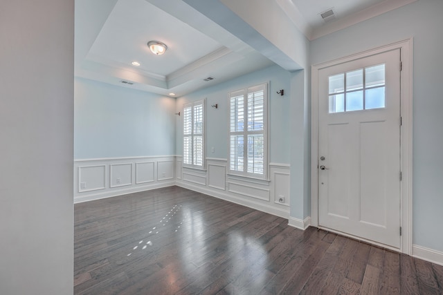 entryway featuring ornamental molding, dark hardwood / wood-style floors, and a raised ceiling