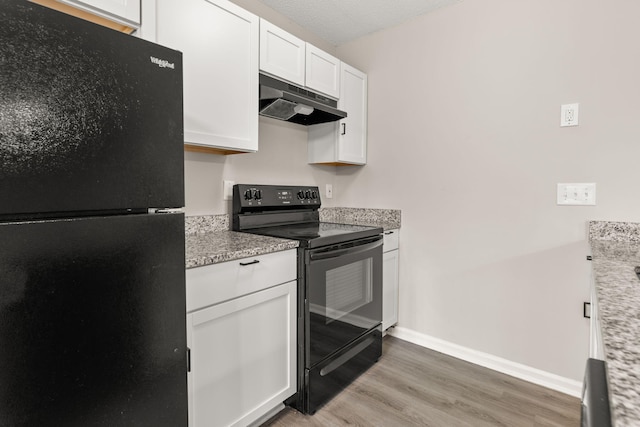 kitchen featuring light stone countertops, a textured ceiling, black appliances, hardwood / wood-style flooring, and white cabinetry