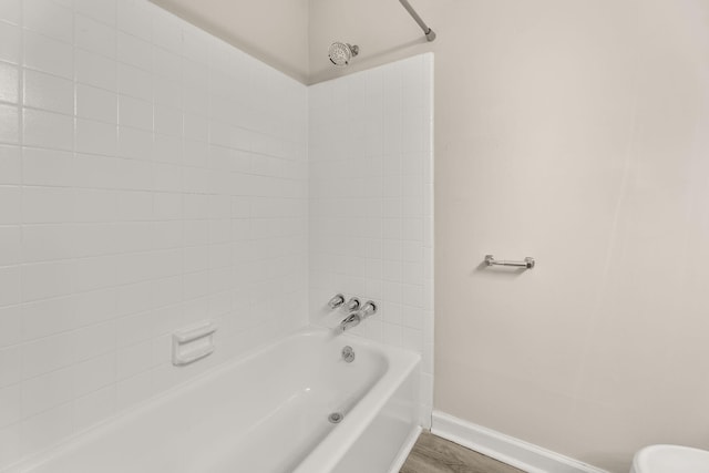 bathroom featuring hardwood / wood-style flooring and tiled shower / bath