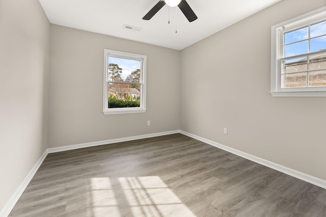 empty room featuring ceiling fan and hardwood / wood-style floors