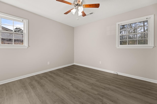 unfurnished room with ceiling fan and dark wood-type flooring