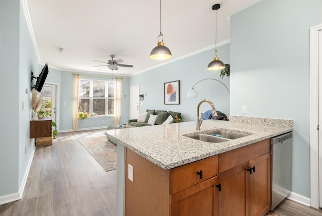 kitchen with sink, hanging light fixtures, stainless steel dishwasher, ceiling fan, and light stone countertops