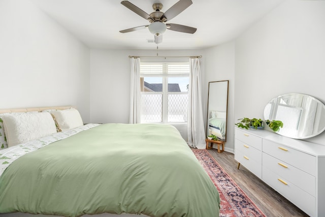 bedroom with ceiling fan and dark hardwood / wood-style flooring