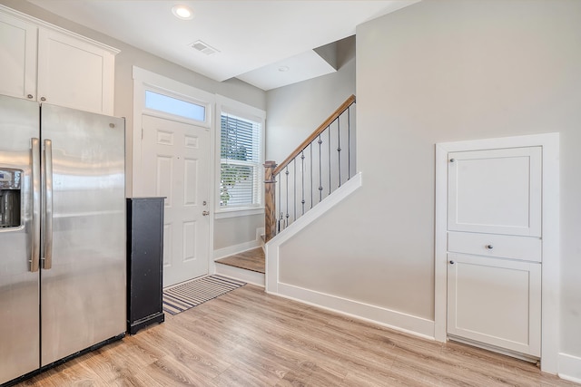 foyer with baseboards, visible vents, stairs, light wood-style floors, and recessed lighting