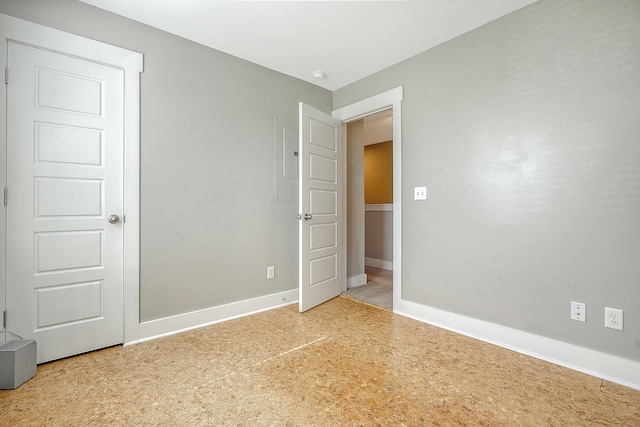 unfurnished room featuring baseboards