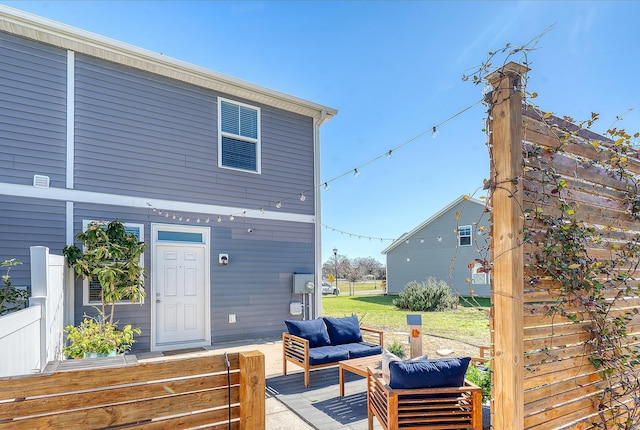 back of property featuring an outdoor living space