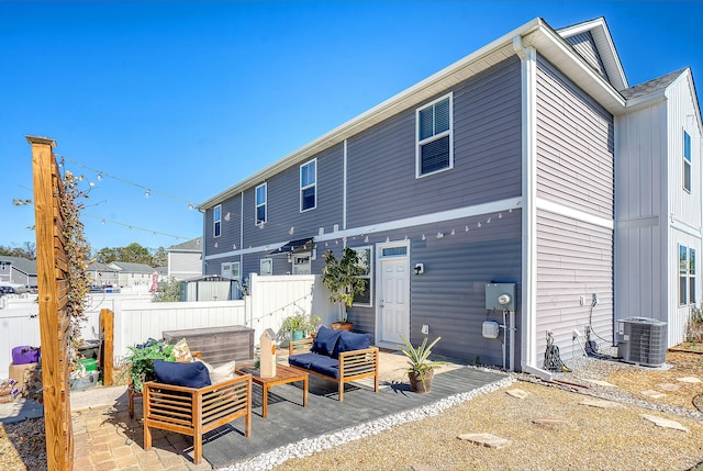 rear view of property featuring a patio area, central AC, and fence