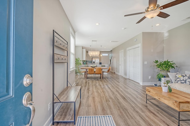 foyer with baseboards, visible vents, a ceiling fan, light wood-style floors, and recessed lighting