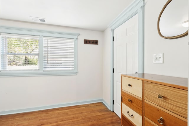 unfurnished bedroom featuring light wood-style flooring, visible vents, and baseboards