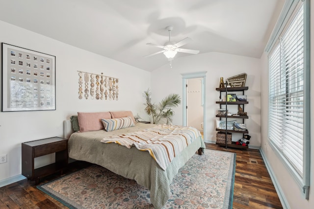 bedroom with lofted ceiling, dark wood-style floors, a ceiling fan, and baseboards