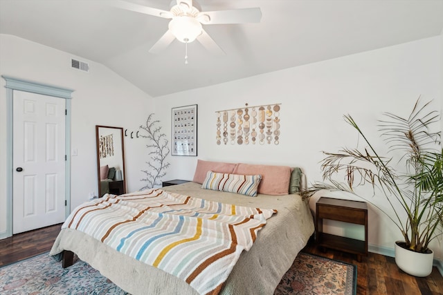 bedroom featuring lofted ceiling, visible vents, dark wood finished floors, and a ceiling fan