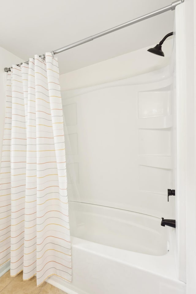 bathroom featuring tile patterned flooring and shower / bathtub combination with curtain